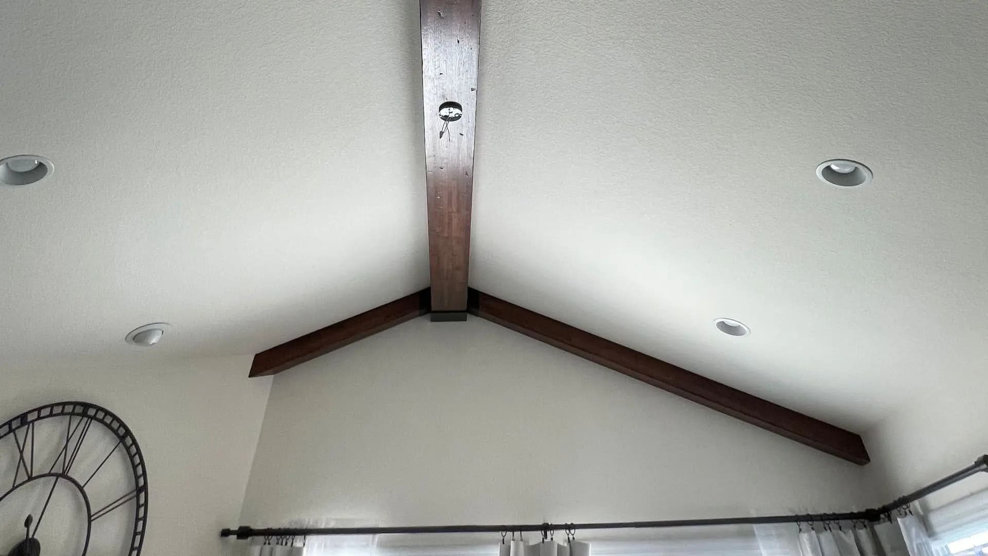 a ceiling with a beam and a shower curtain