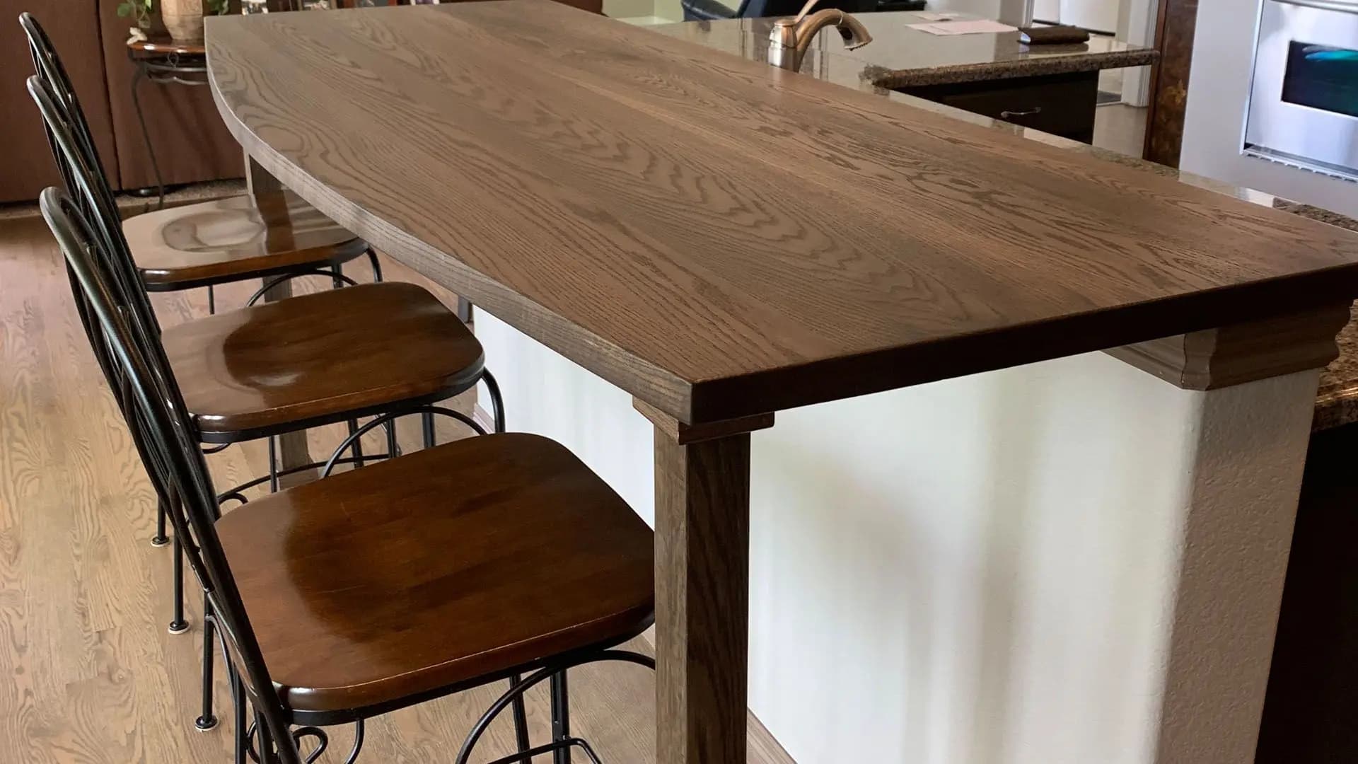 a table with stools in a kitchen