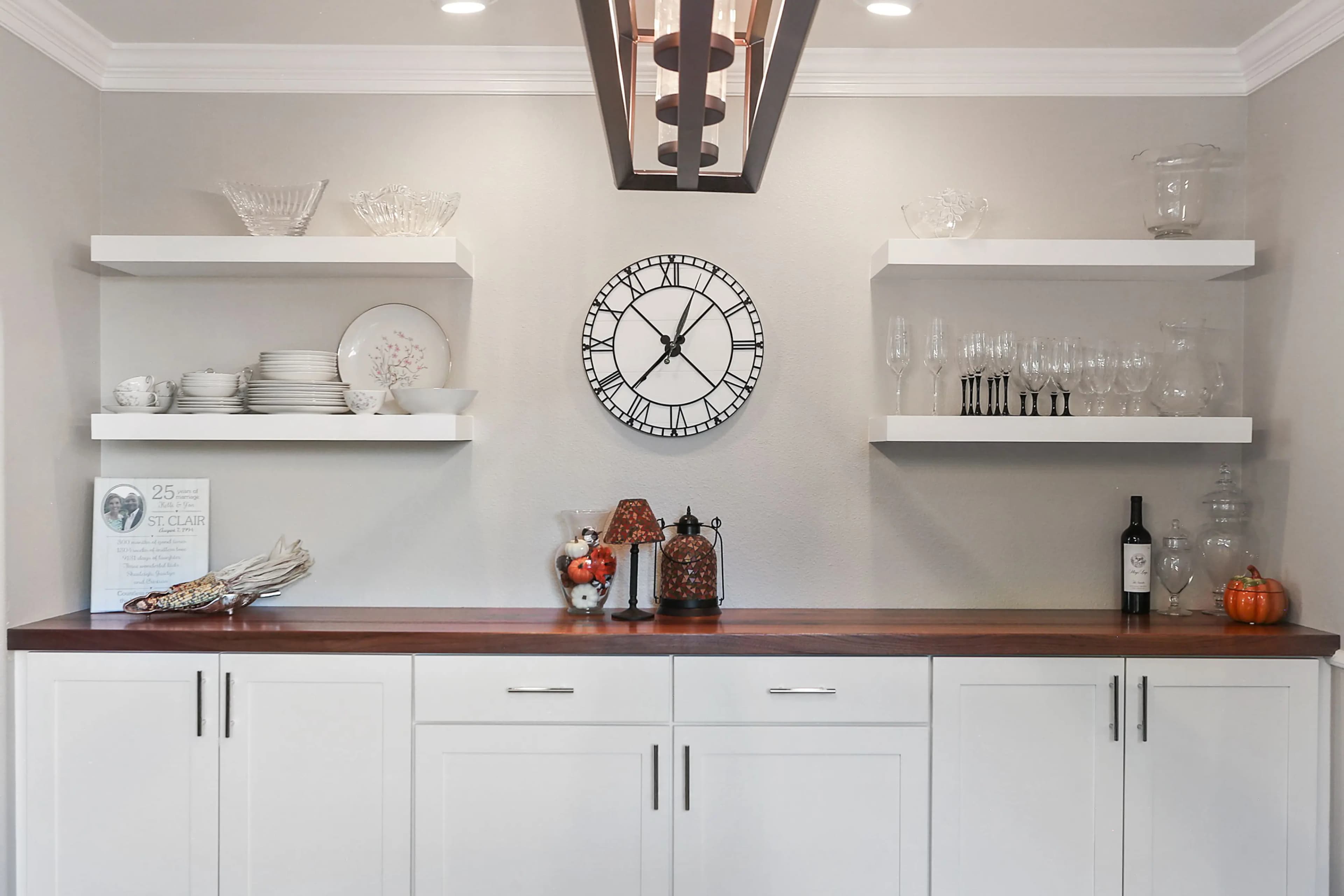 a white wall this clock and plates