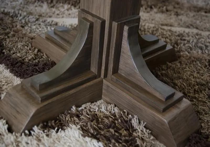 a wooden base on a carpet