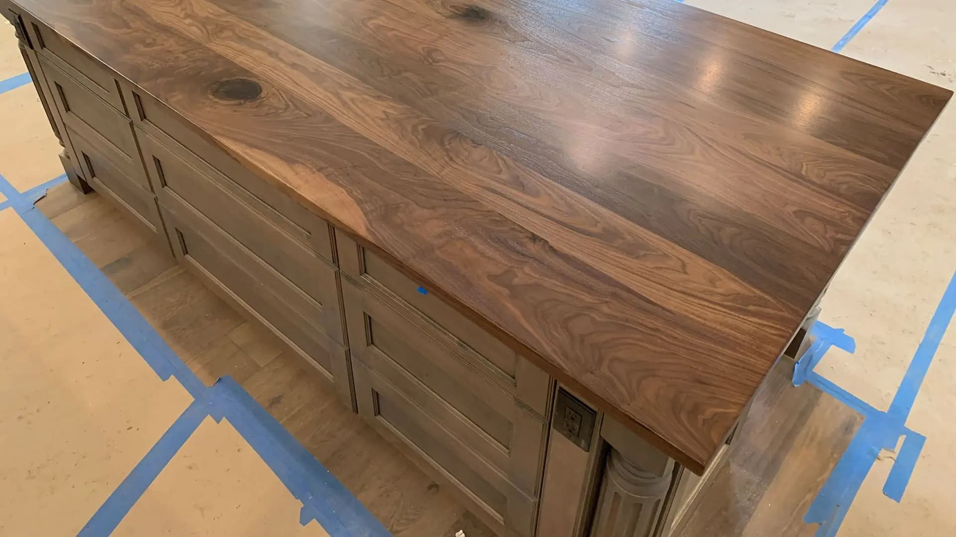 a counter top with drawers and a blue tape