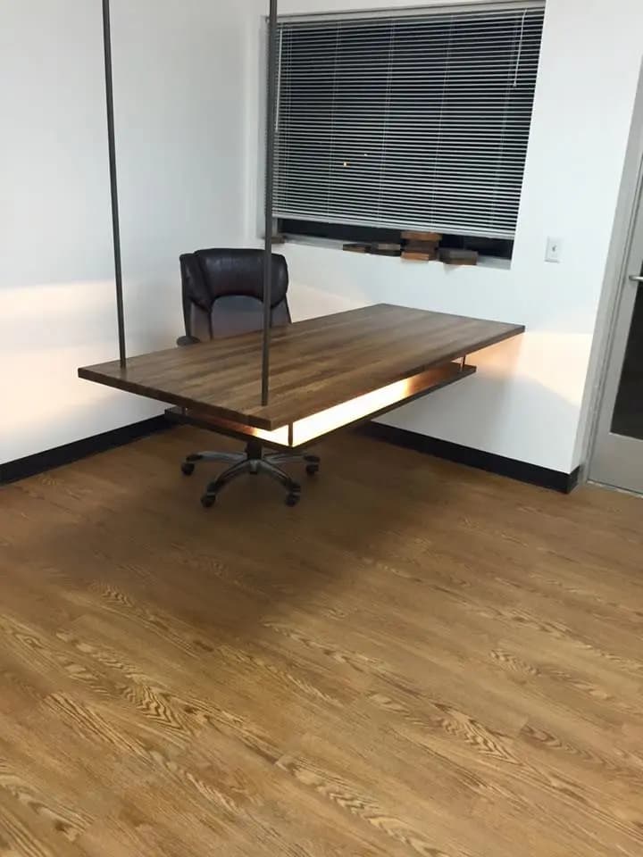 a desk with a chair in the corner