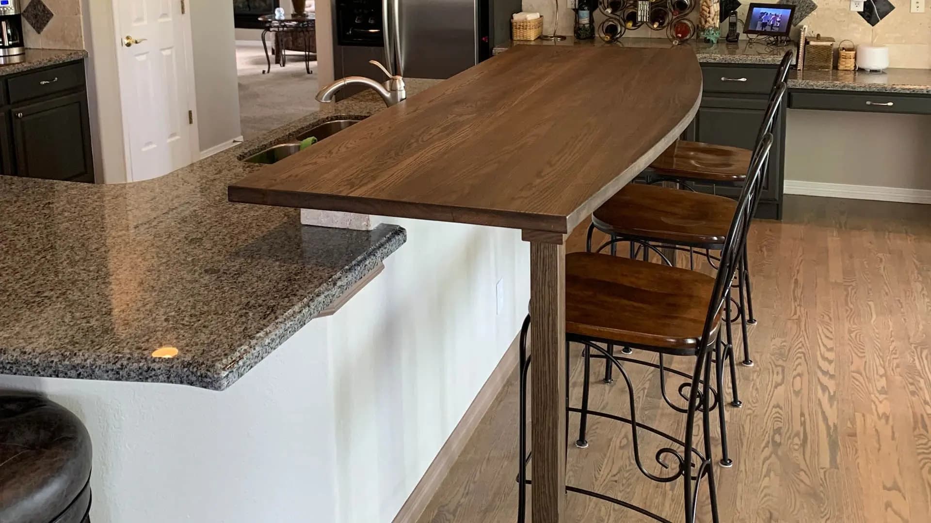 a kitchen with a bar and a refrigerator