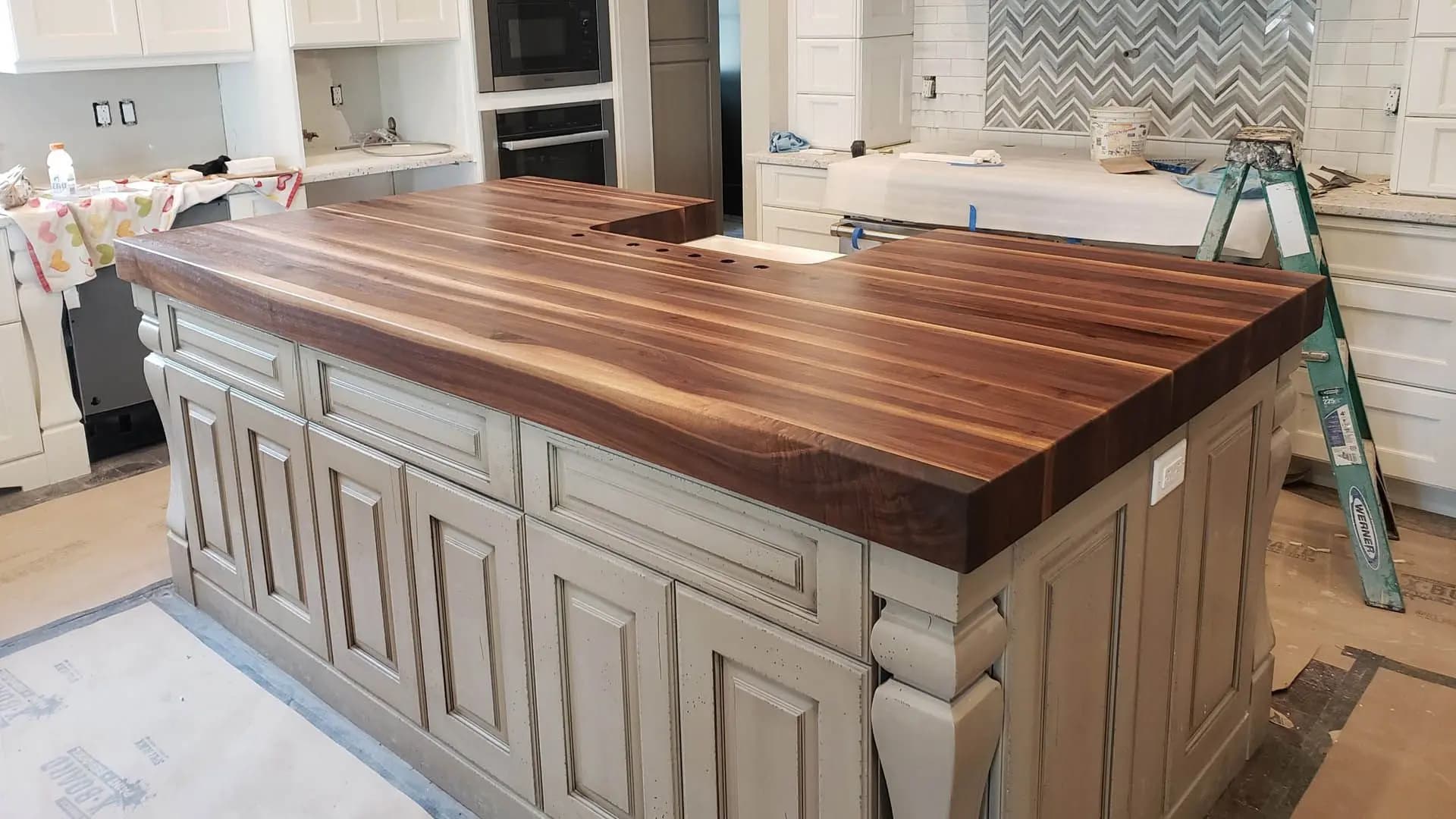 a kitchen island with a wooden counter top