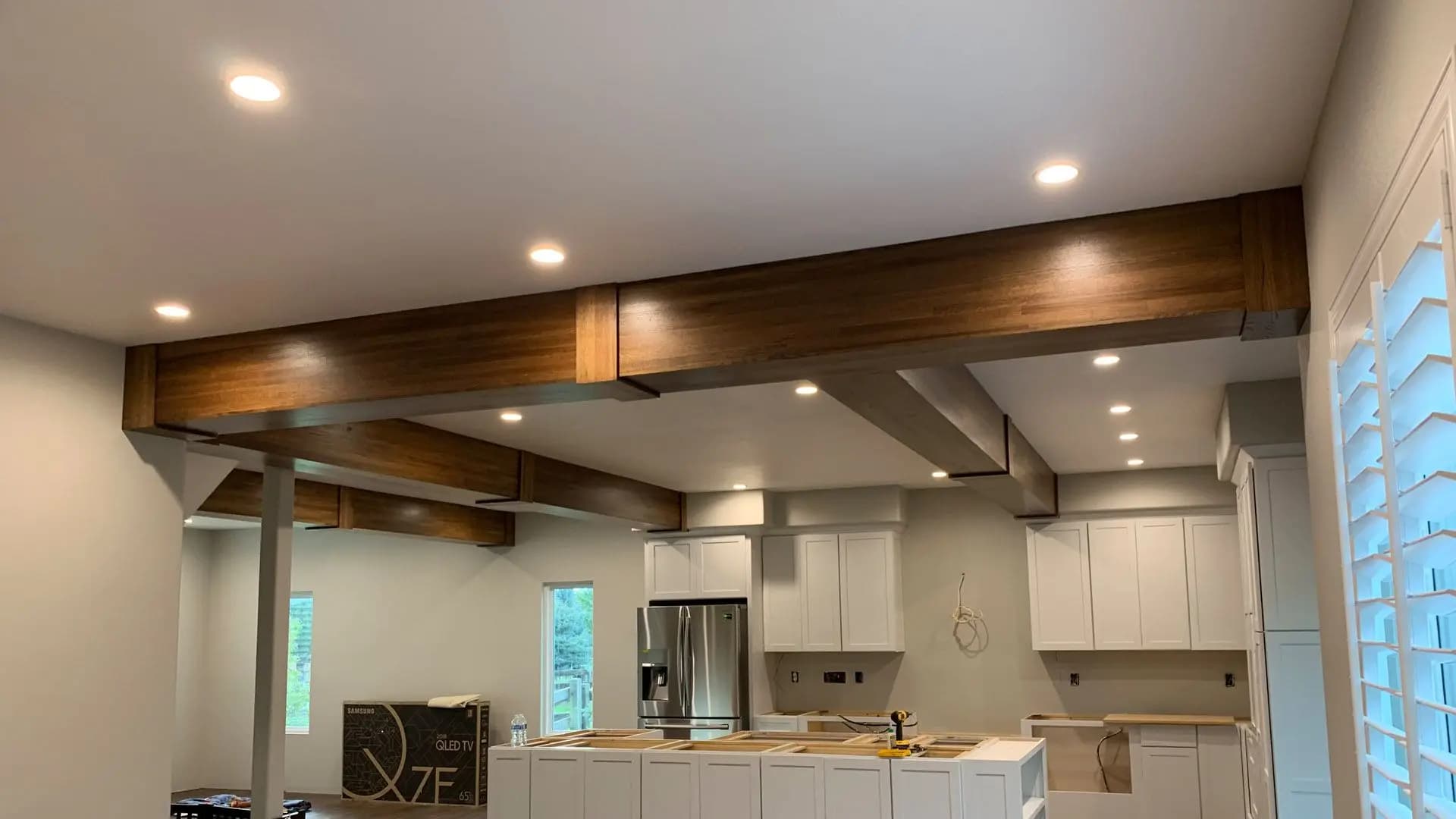 a kitchen with a wooden beam