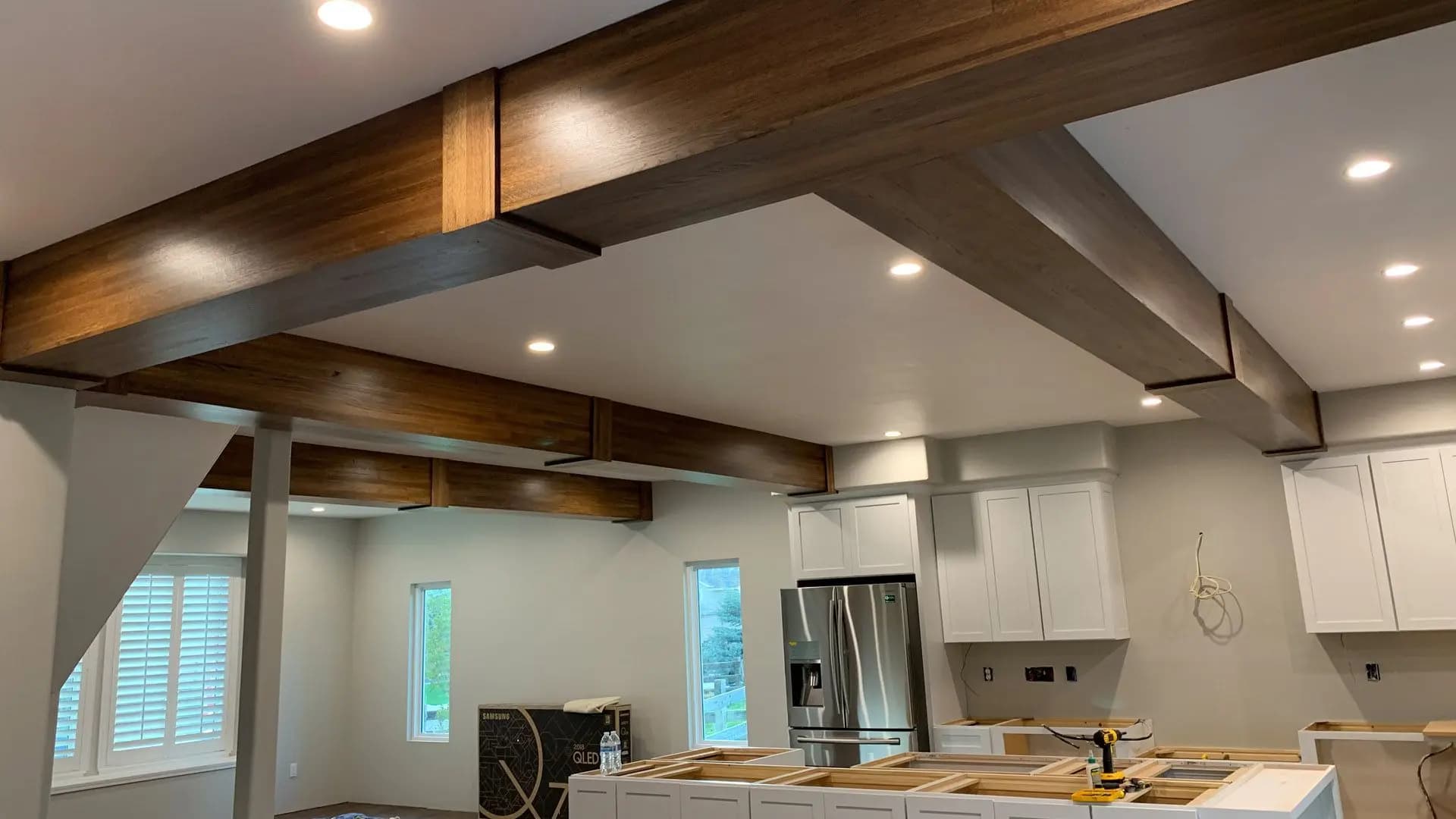 a kitchen with wood beams and a refrigerator